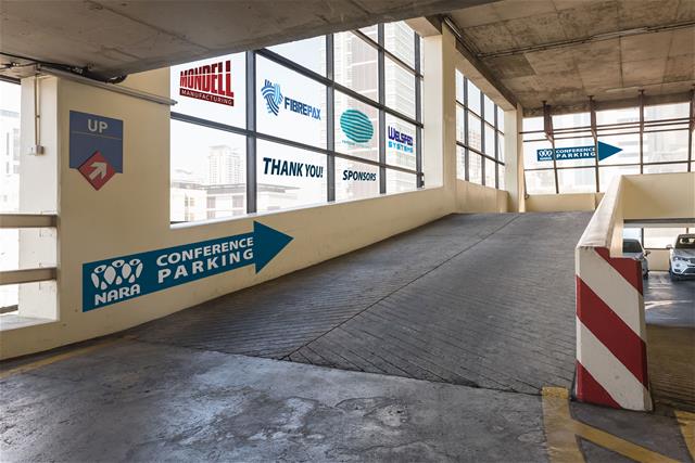 A parking garage features cement graphics with directions