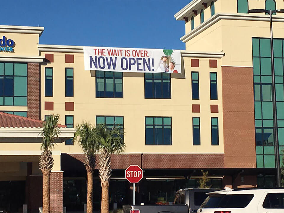 “Now Open” banner